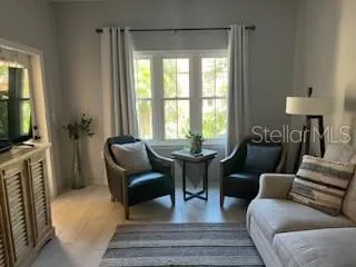 Part view living area, window with views of common area, left side door to larger balcony!