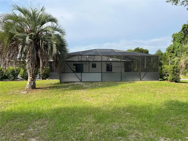 Back of home with enclosed pool