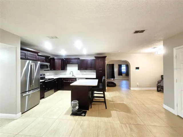 Front entrance view of kitchen and formal dining area