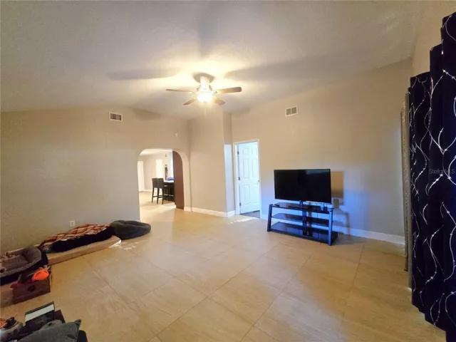 second view of family room leading to kitchen or primary room one