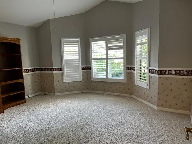 This is the 3rd Bedroom.  It is set up to be a Den or a Study.  We kept the Golfer Motif, and painted above the boarder.  This room is carpeted and faces the street
