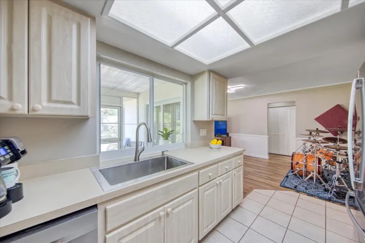 Beautiful light & bright kitchen featuring light driftwood finish panel door cabinets with coordinating counters~
