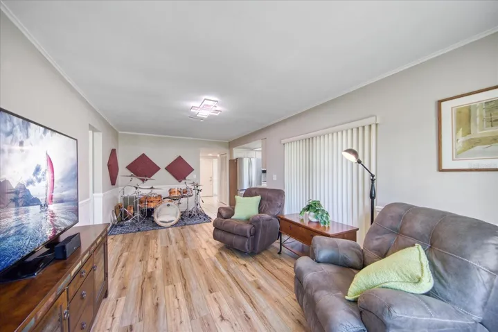 Space perspective of family room open to breakfast nook or entertaining space, and newer sliders out to the Florida room~
