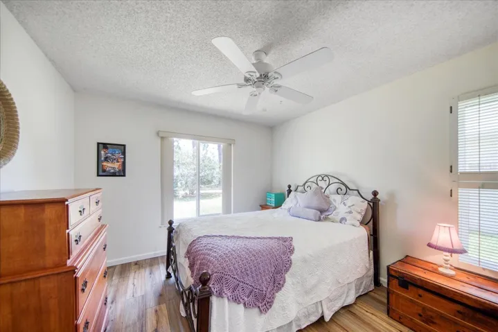 The guest bedroom located on the opposite side of the master offering privacy, beautiful views of the backyard & a walk-in closet~