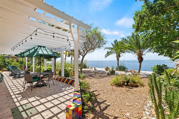 Step into your backyard and unwind under a large pergola, seeing butterflies and florida birds.