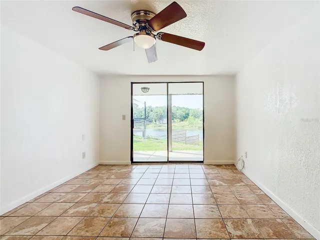 Ceramic tile flooring in the master bedroom and a ceiling fan with light.
