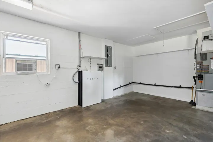 Divided room in main house garage housing generator and solar battery