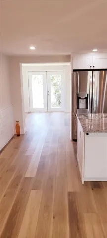walkway to dining room with doors opening to the back yard
