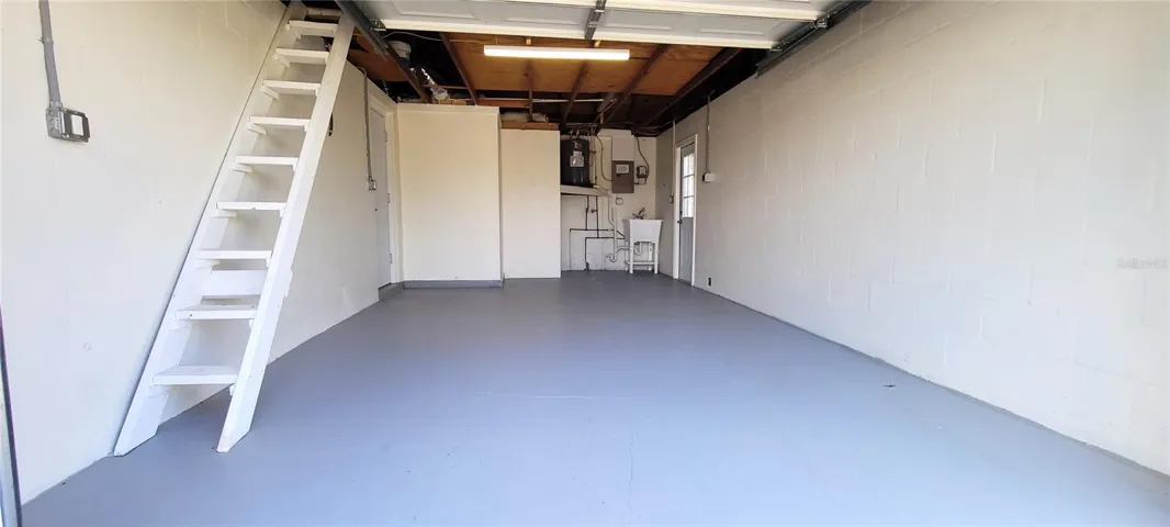 Garage with ladder to attic- washer and dryer hook-up.  New water heater and new utility tub