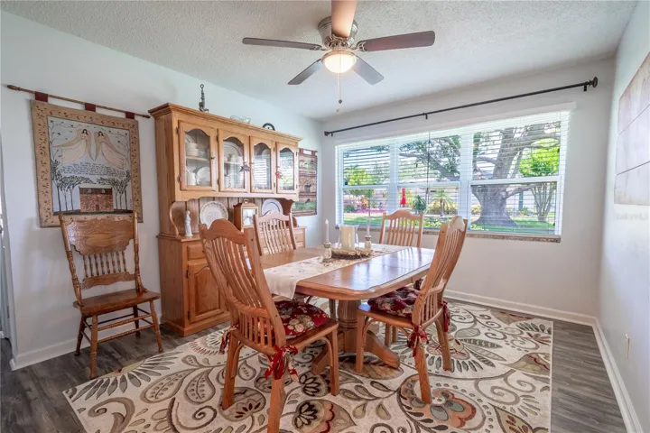 The dining room features a picture window with a view of the majestic oak tree.