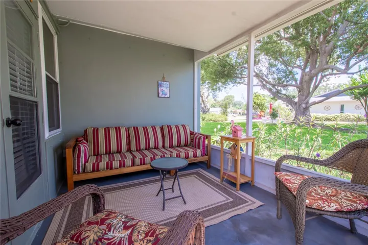 A screened in back porch is the ideal spot for relaxation and taking in the garden view