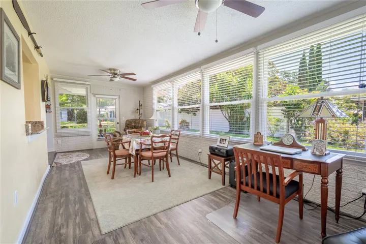The Florida Room features wood plank vinyl flooring and two ceiling fans for year round comfort.