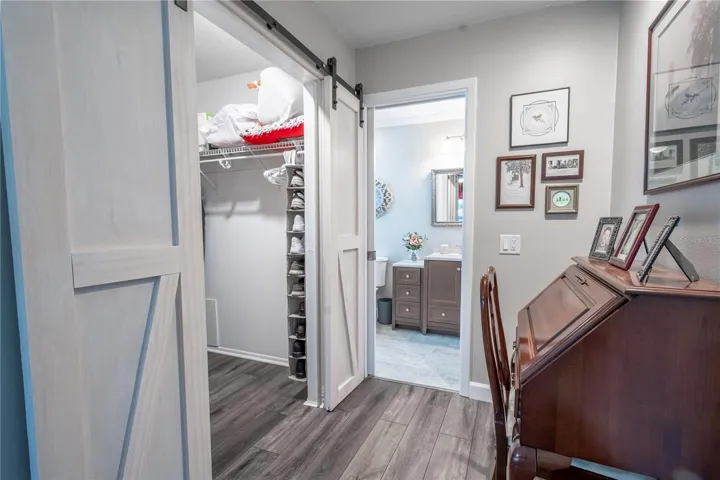 The primary bedroom features a spacious walk-in closet with barn door.