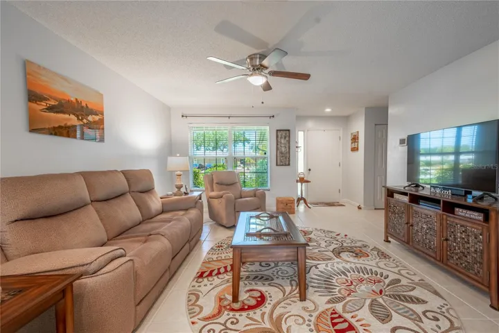 The living room has a picture window that frames the view if the flower bed outside.