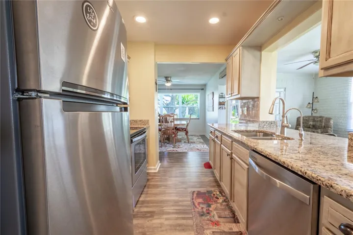 The kitchen features a suite of stainless steel appliances.