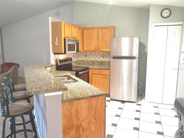 kitchen with granite countertops and wood cabinets
