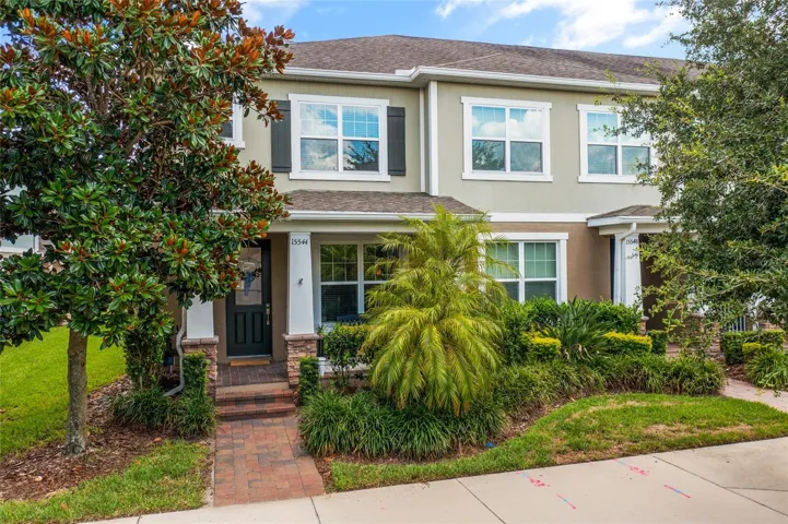 END UNIT with great front porch and rain gutters.