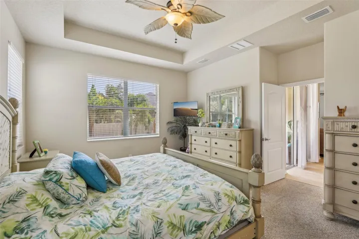 Primary Bedroom overlooking pool and backyard