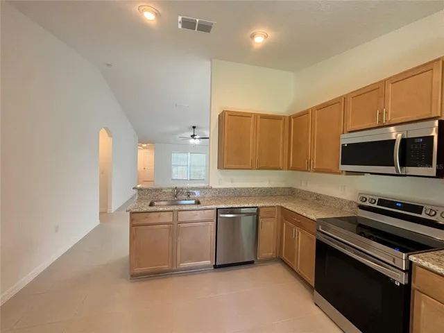 The brand new kitchen with granite countertops and stainless appliances