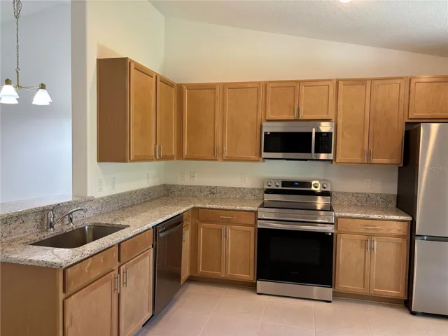 The brand new kitchen with granite countertops and stainless appliances