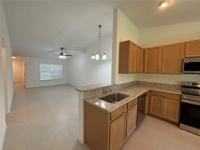 The brand new kitchen with granite countertops and stainless appliances