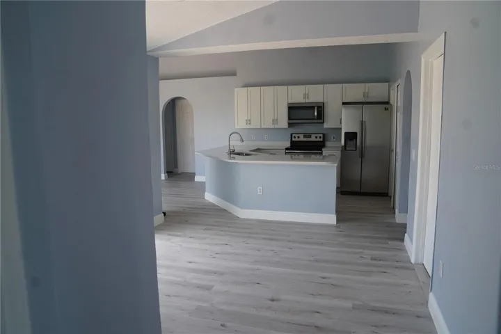 looking at kitchen from master bedroom area also overlooking dining area