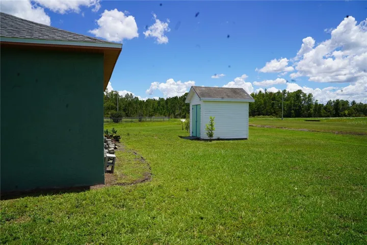 large backyard with tool shed