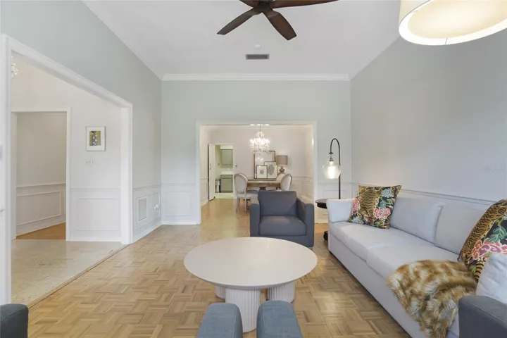 Living Room with crown molding and wainscoting