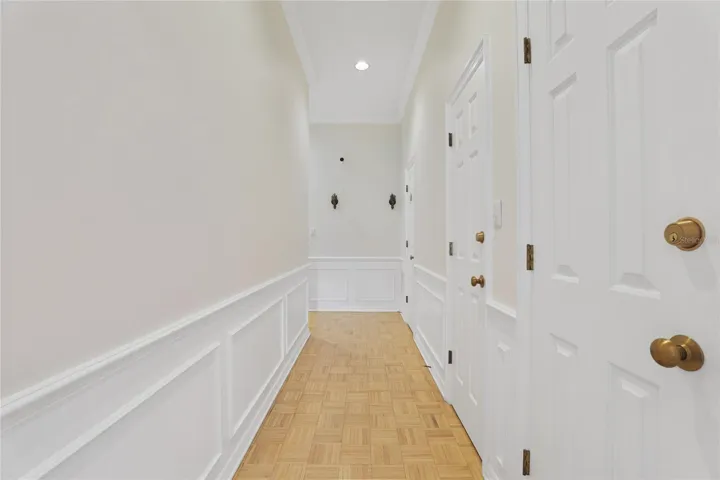 Central gallery hall with storage closet and coat closet