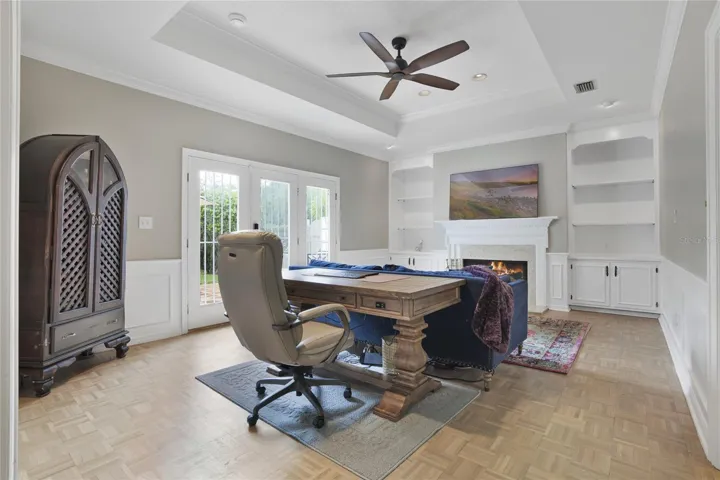 Family room with tray ceiling and built-ins