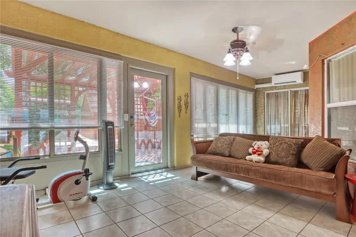 Porch- features doors and windows that can be opened or keep closed as additional living space with a split a/c unit already installed.
