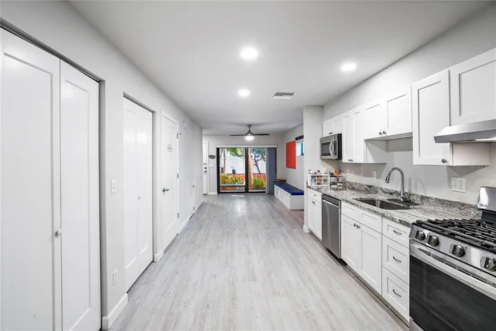 Pantry, laundry closet and ADA powder room on left.