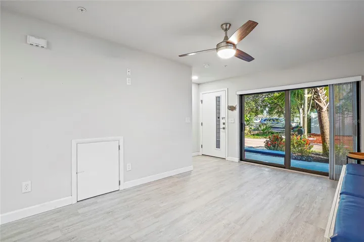 Sliding glass doors open to front patio and (small door) opens to understairway storage.