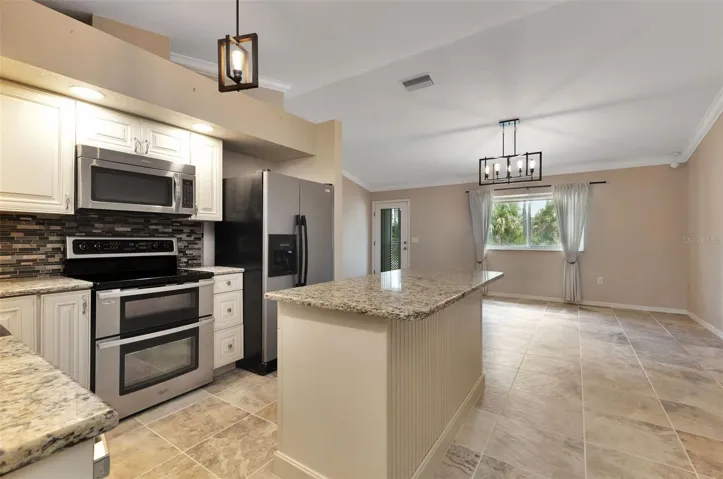 Kitchen opens up to living room.