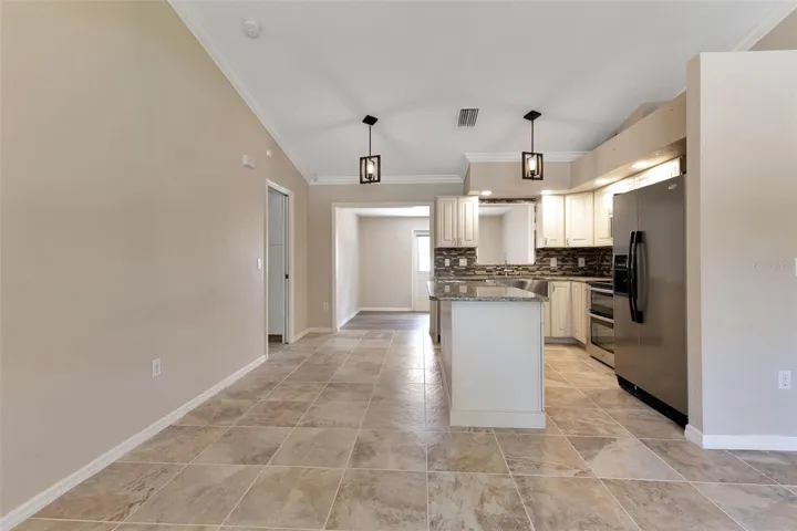 Kitchen features soft close cabinets and drawers, and updated light fixtures.