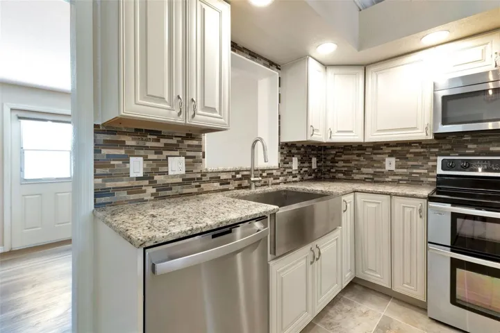 Granite countertop and stainless steel farmers sink.