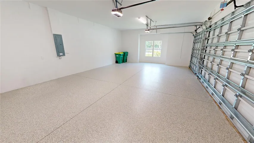 Three-car attached garage with epoxy floor