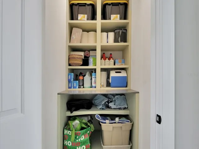 Storage room with built-in wood shelving. Plenty of storage!