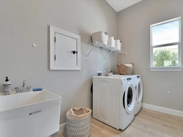 Functional laundry room with sink.