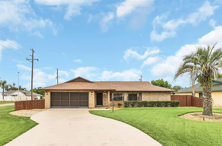 3/2 Brick POOL home with 2022 roof on corner lot with a covered entry and gutters.