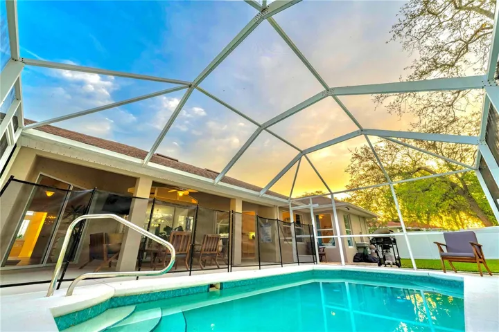 Private pool with screen cage and removable safety fence