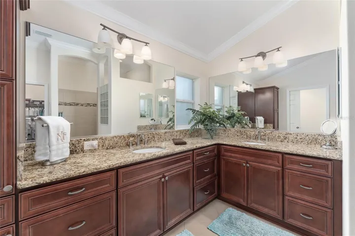 PRIMARY EN SUITE BATH HAS WRAP AROUND VANITIES AND DUAL SINKS.