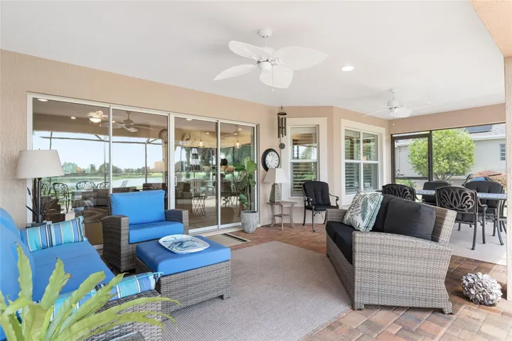 NICELY FURNISHED LANAI OFFERS SEATING AREA, DINING AREA AND IS OPEN TO LARGE SCREENED PATIO.
