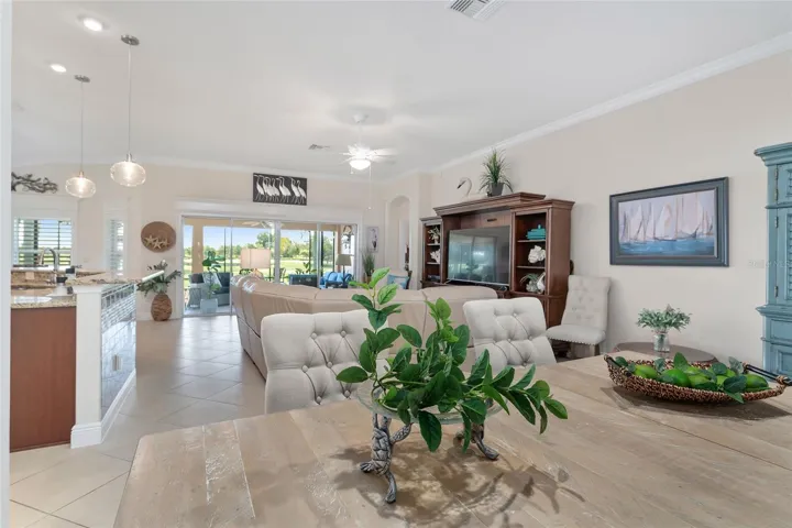 DINING AREA THROUGH LIVING AREA TO LANAI AND GOLF.