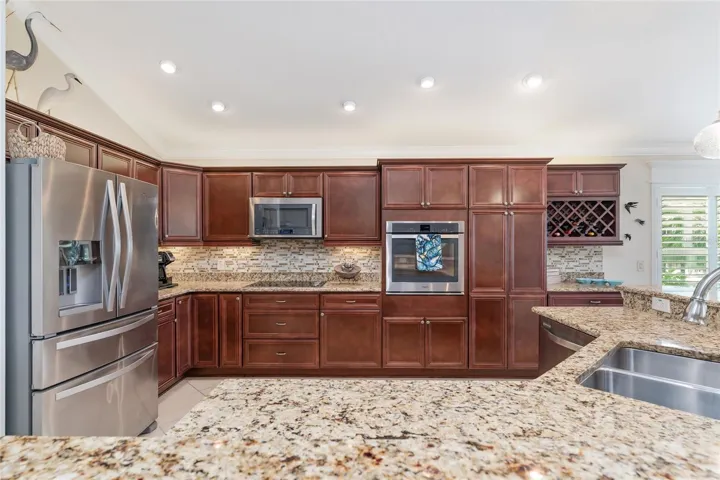 KITCHEN IS EQUIPPED WITH STAINLESS STEEL APPLIANCES.