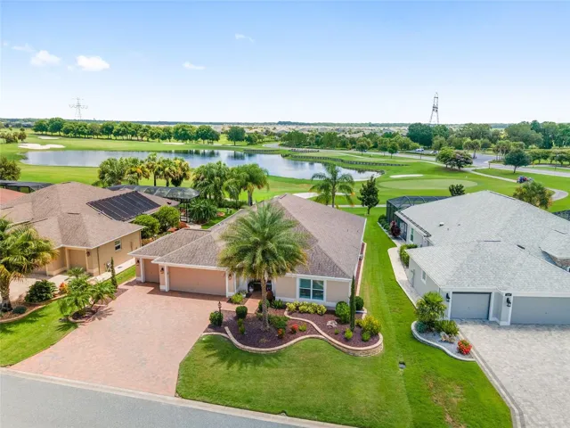 AERIAL FRONT OF HOME TO GOLF AND LAKE. BEAUTIFUL LOCATION!