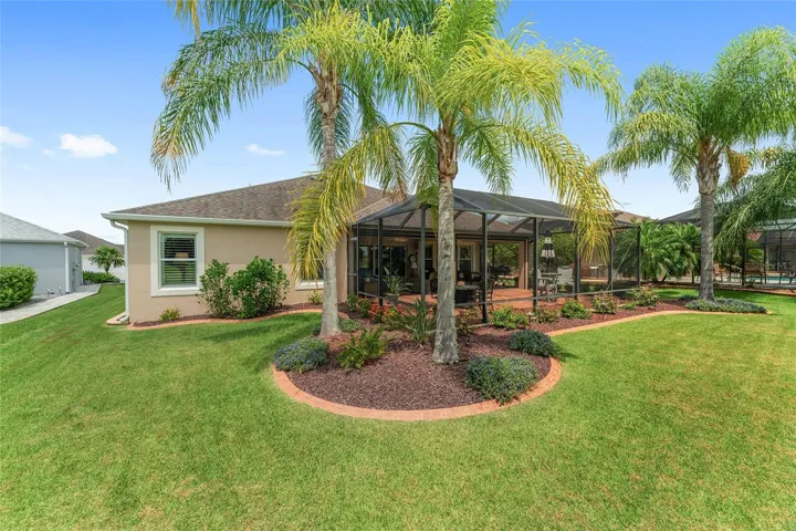 LARGE BIRDCAGE WITH PAVER PATIO ABUTS COVERED LANAI.