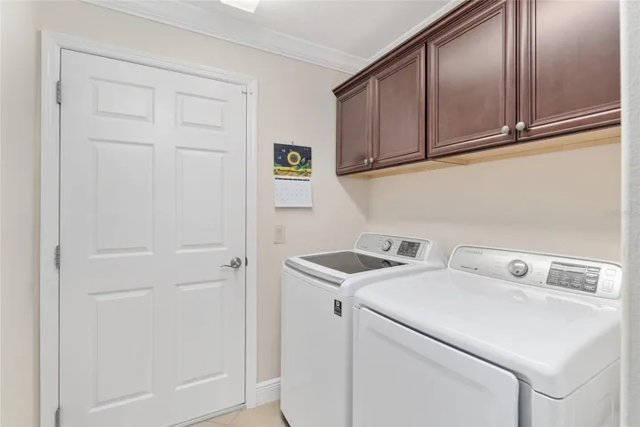 LAUNDRY ROOM LOCATED BETWEEN KITCHEN AND GARAGE.