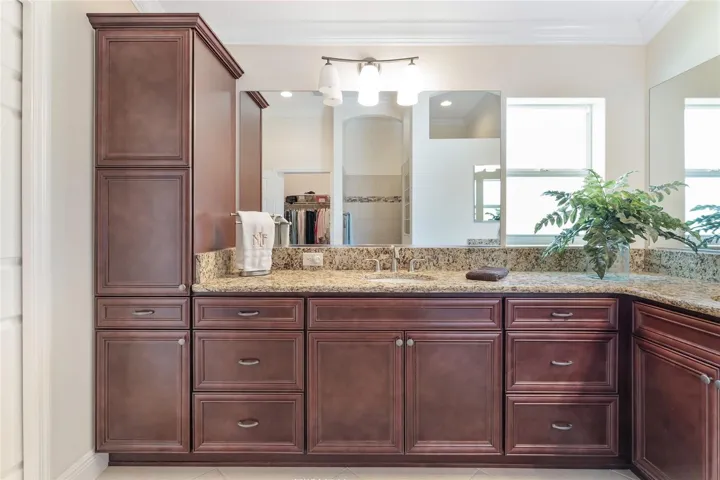 WINDOW ADDS NATURAL LIGHTING TO PRIMARY BATH. UPGRADES INCLUDE CHERRY CABINETRY AND GRANITE COUNTERS.