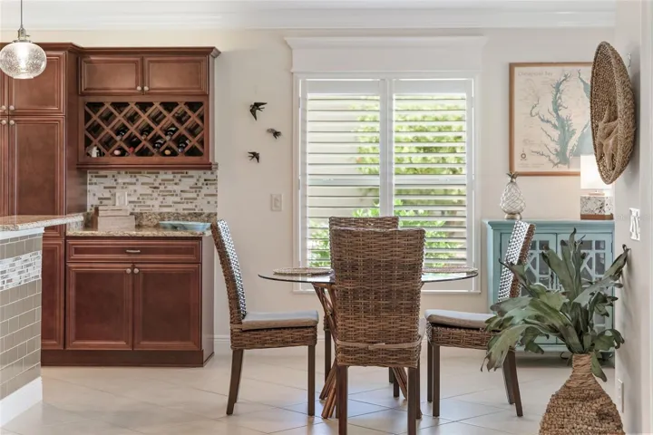 BREAKFAST AREA WITH ADDED STORAGE AND WINERACK. CUSTOM CROSSHEADS ON ALL WINDOWS AND DOORS.